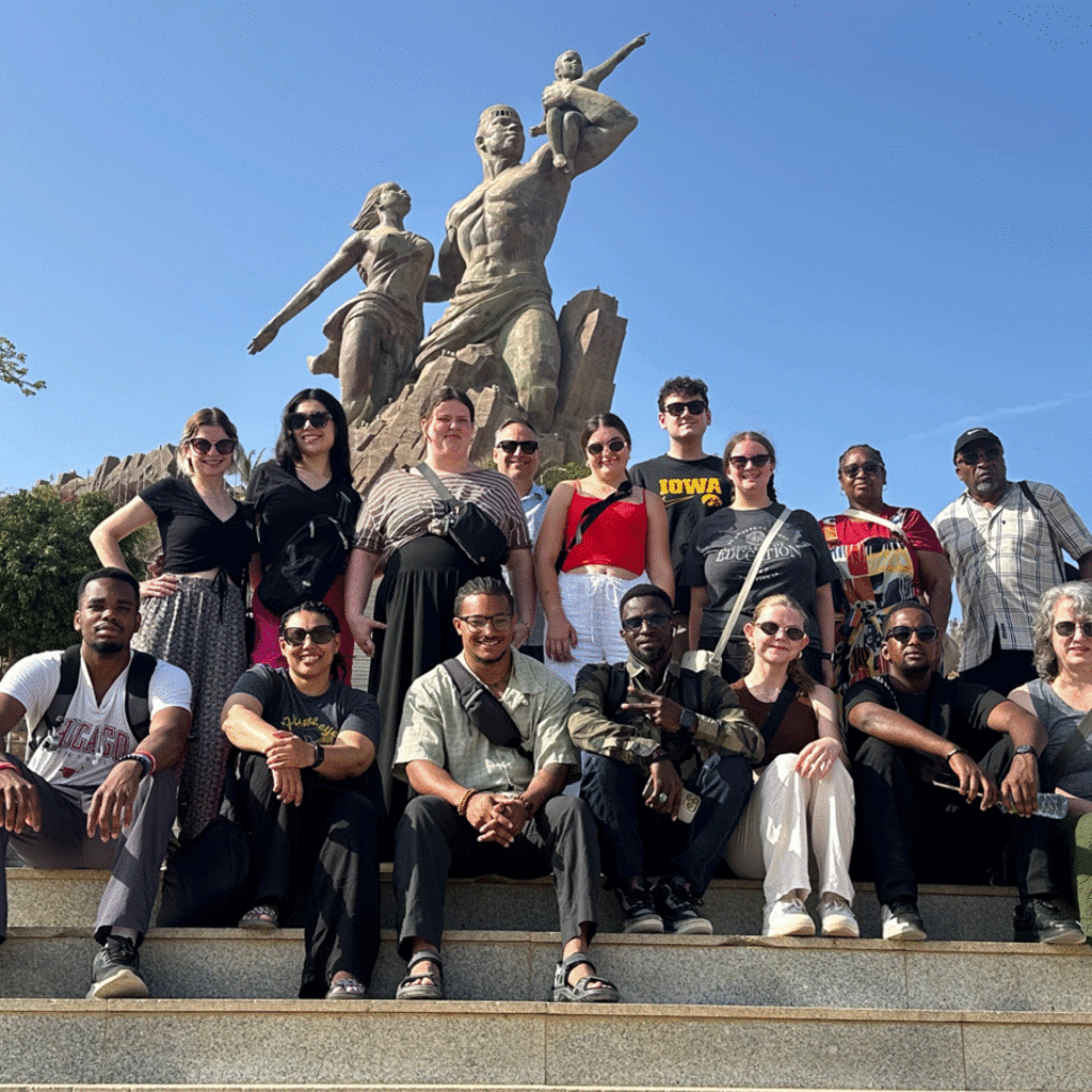 students standing in front of statue in Senegal