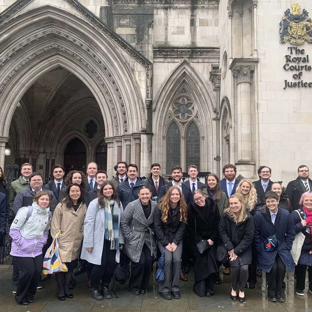 law students standing in front of the Royal Court of Justice