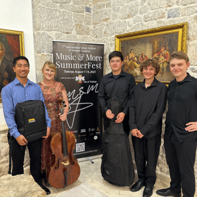 Kenny Lee and other musicians standing with their instruments