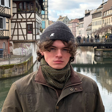 student posing for photo on canal