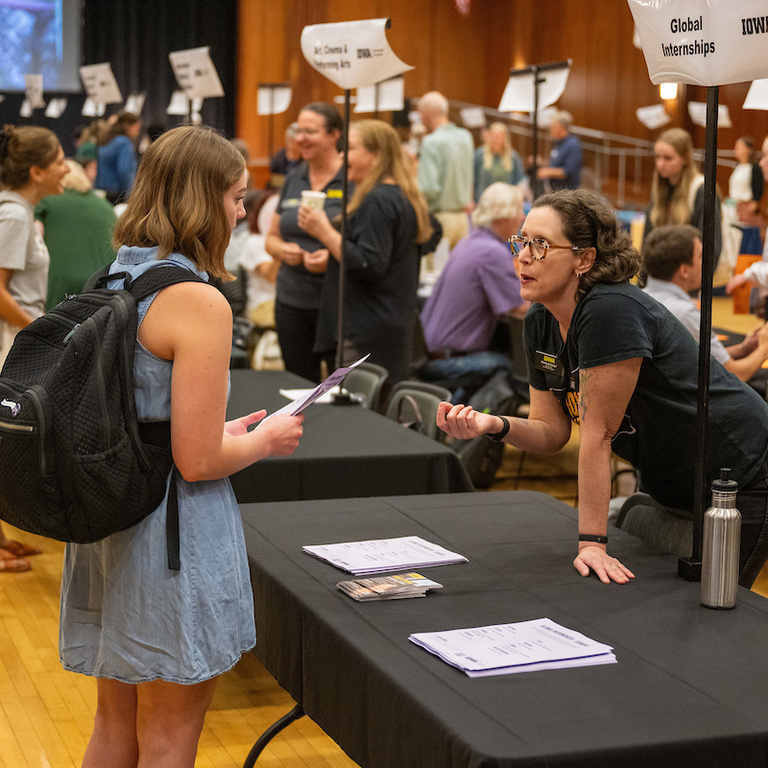 student talking at someone at table