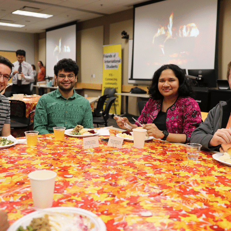 people sitting at Thanksgiving decorated table