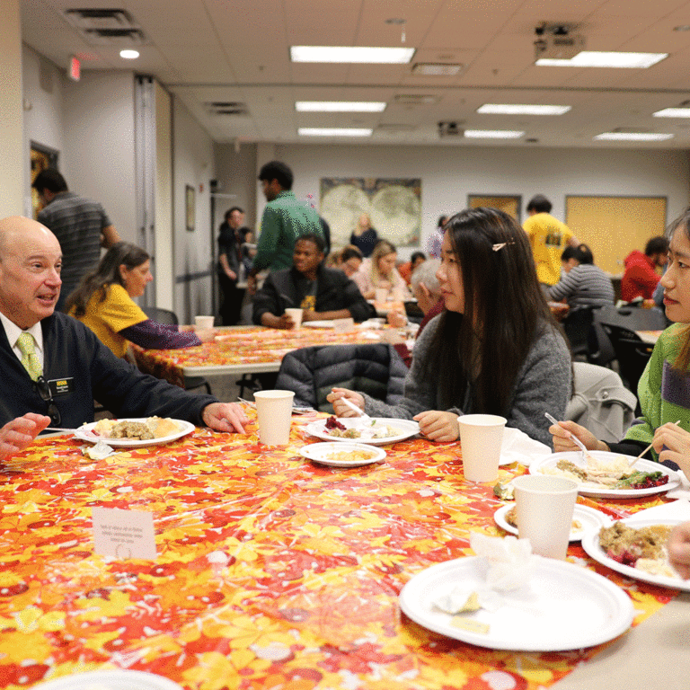 two students speaking with Russ Ganim
