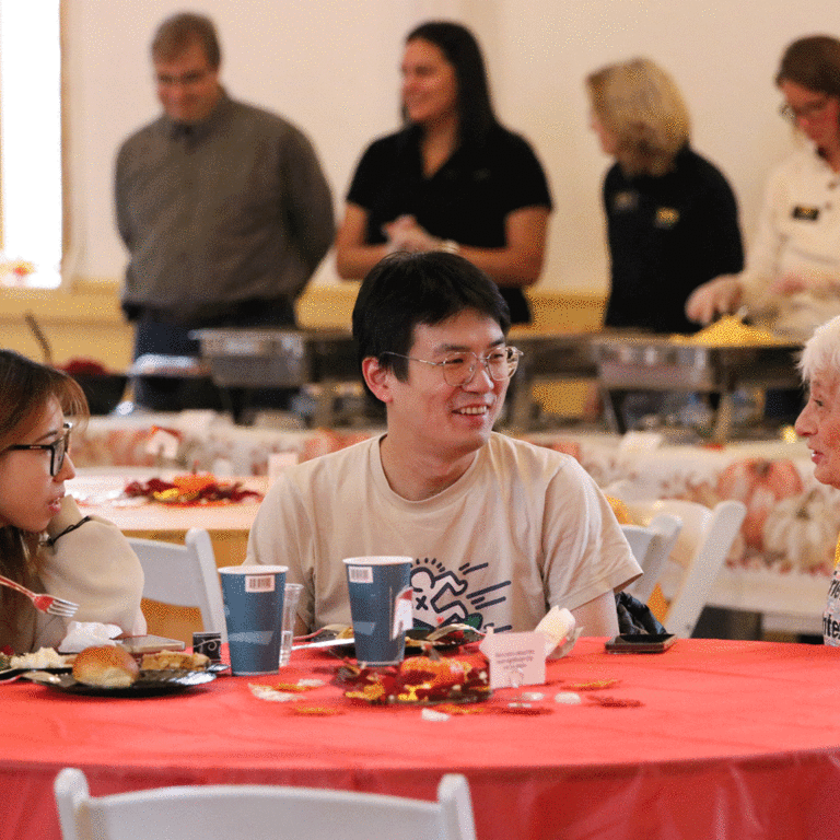 two students and a community member talking