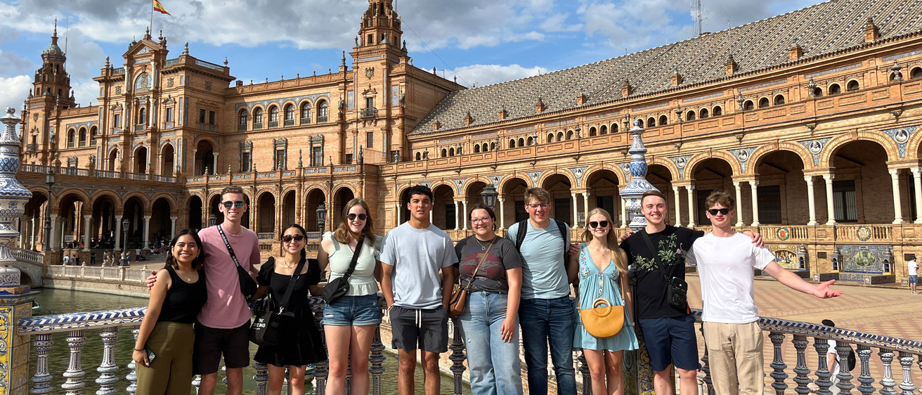 students in front of large building with arcs in Sevilla, Spain