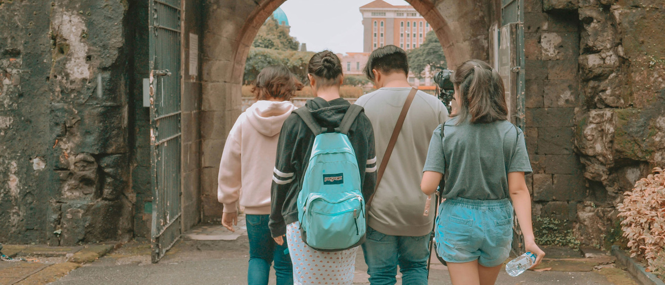 students walking through arch