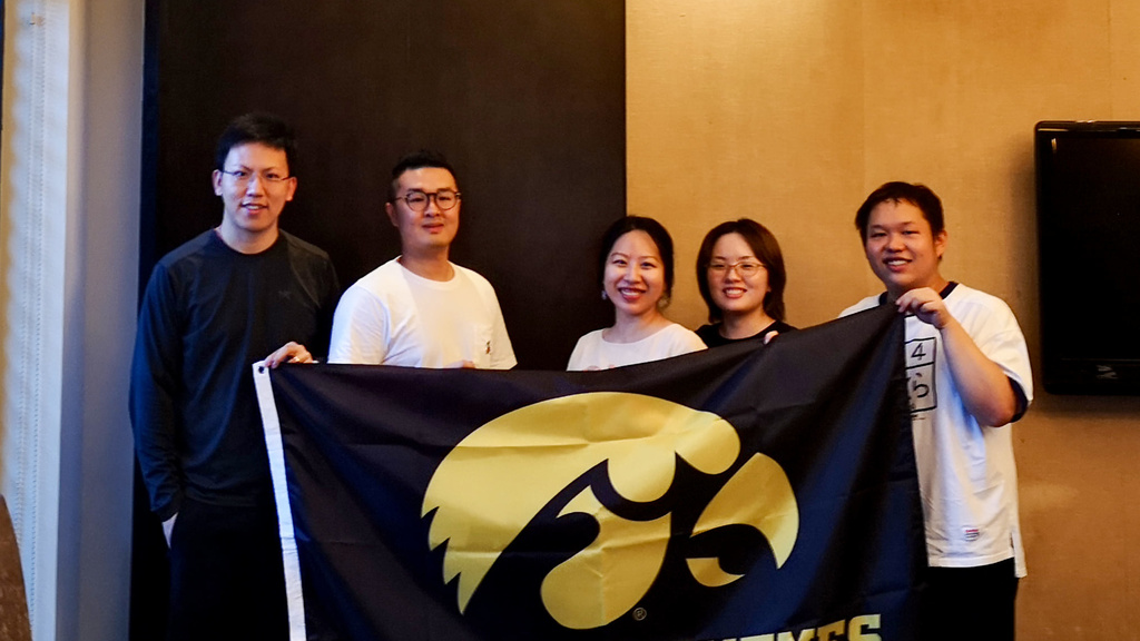 International alumni group in Wuhan, China holding Iowa flag