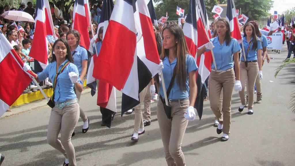 Women walking with flags in the Dominican Republic