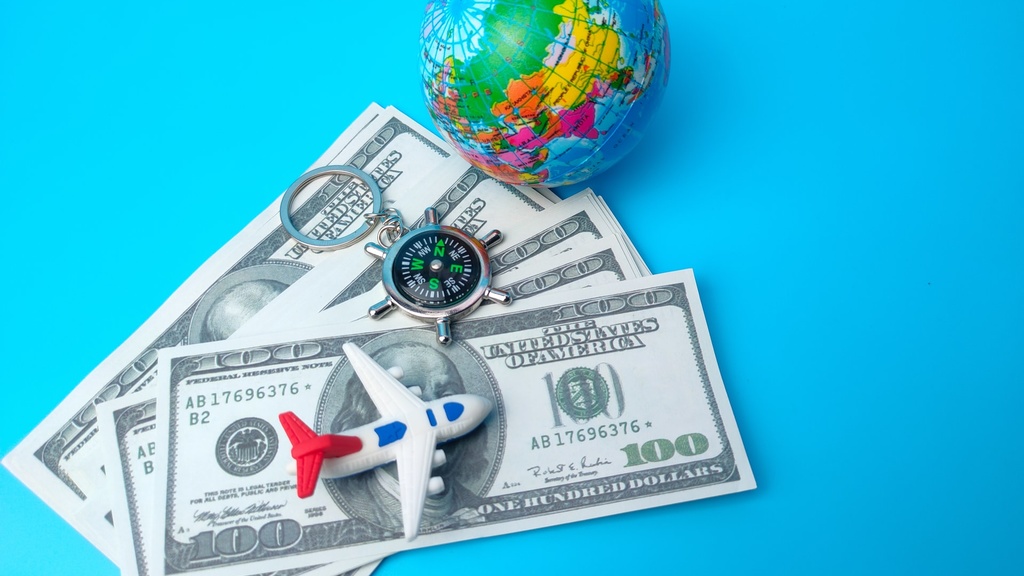 toy airplane and globe on dollar bills