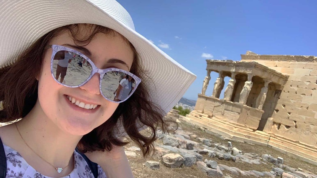 Kaitlyn Dwyer in front of an ancient building with columns in Greece