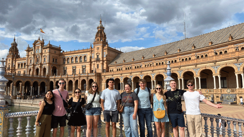 student group standing in front of colorful building in Sevilla