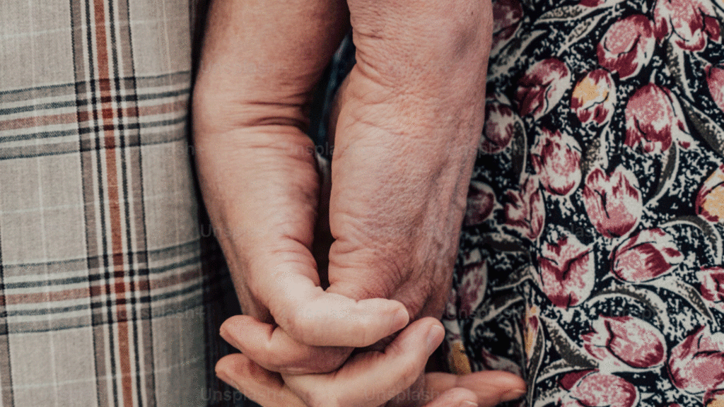 the hands of two elderly people holding hands