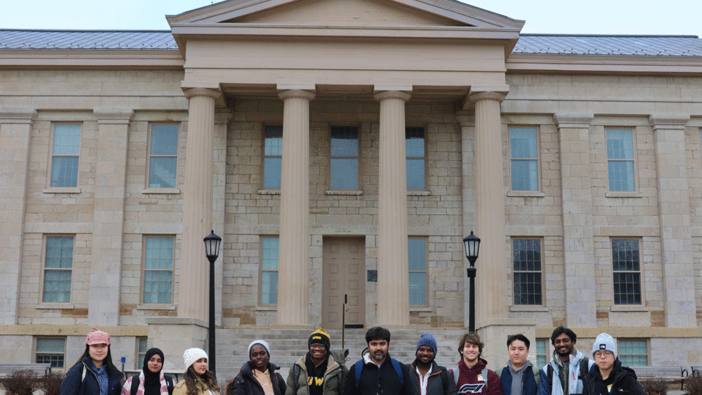 international students standing in front of Iowa Old Capitol building