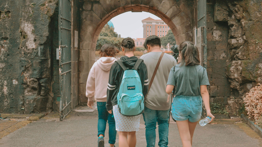 students walking through arch