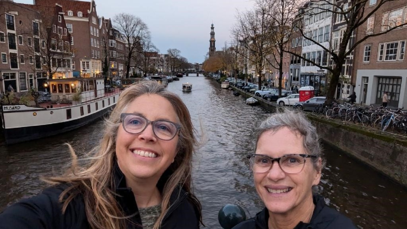 Betty Mallen and colleague in front of canal in Netherlands